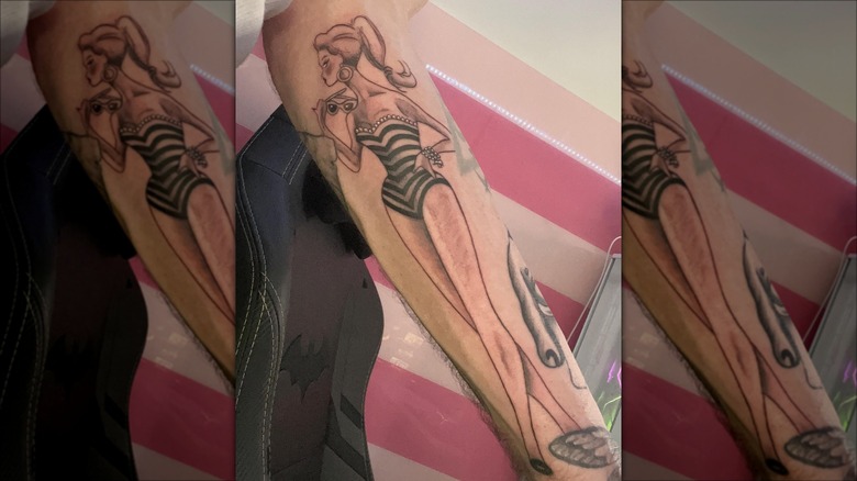 arm with vintage barbie tattoo