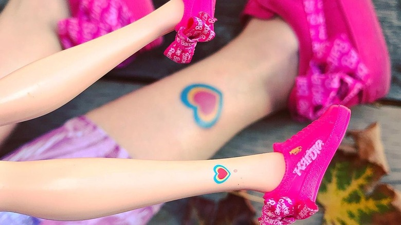 woman and barbie matching ankle tattoos