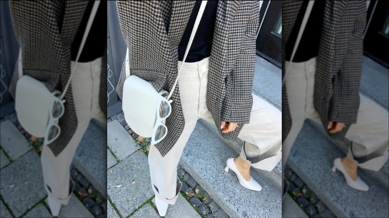 A woman wearing baggy jeans and high heels