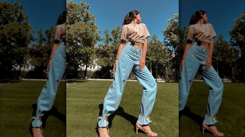 A woman wearing baggy jeans tied around her ankles