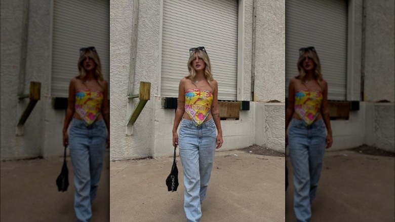 A woman wearing baggy jeans with a colorful top