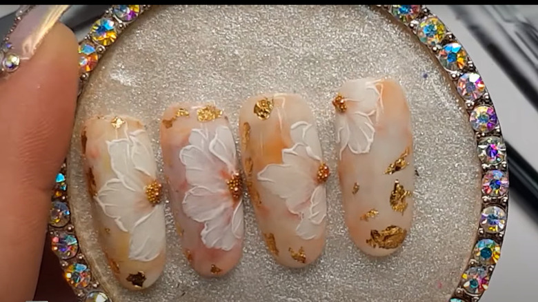 Hand-painted gold and white manicure