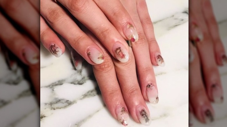 Nude manicure with cherub nail art