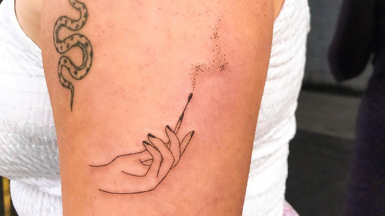Burnt out match tattoo