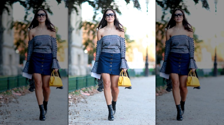 Woman wearing off the shoulder top in Paris