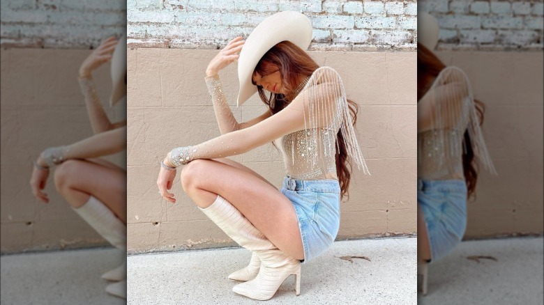 Woman kneeling in rhinestone outfit