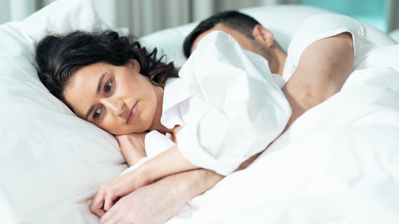Sad woman cuddling husband