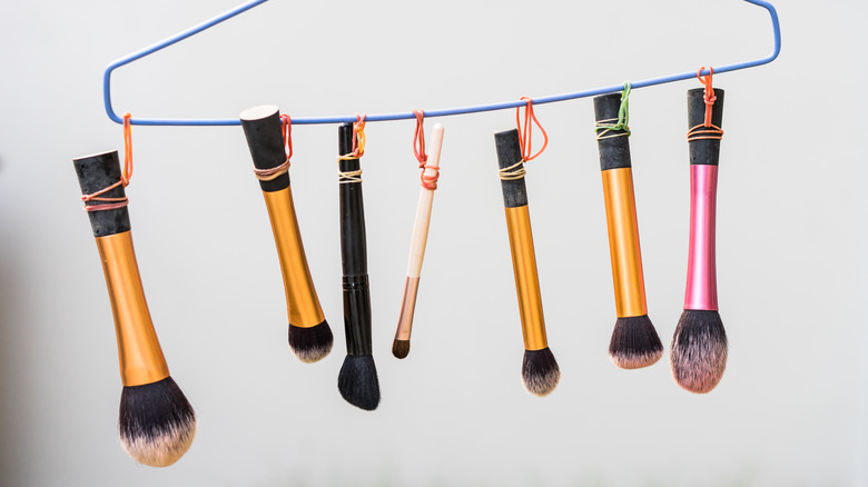 makeup brushes hanging from wire