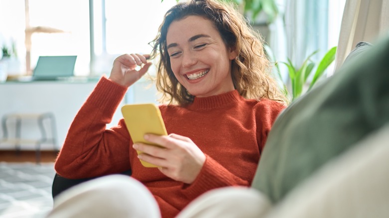 Woman smiling at her phone