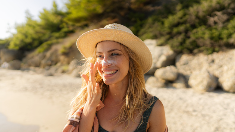 Woman applying sunscreen