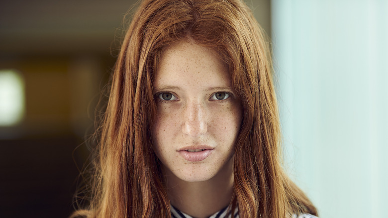 A woman looking disinterested and angry.