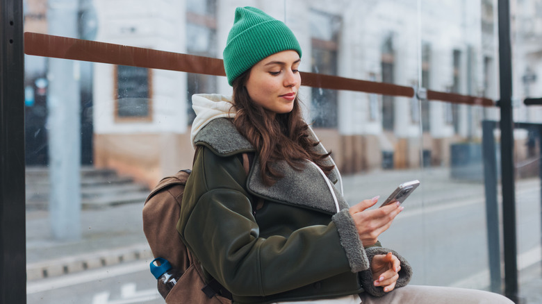A woman in a beanie on her phone