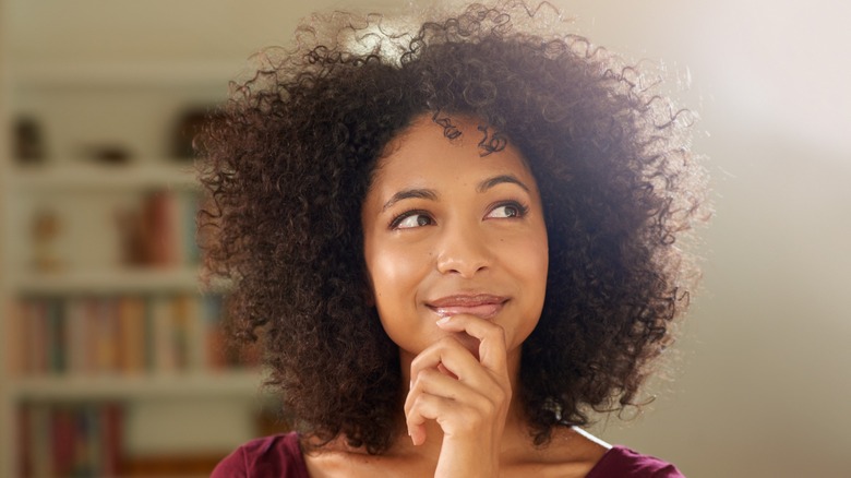 woman smiling and pondering