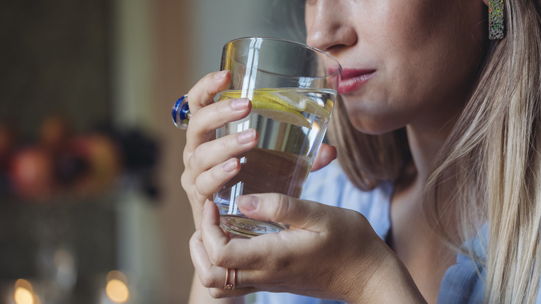 Woman holding glass of water