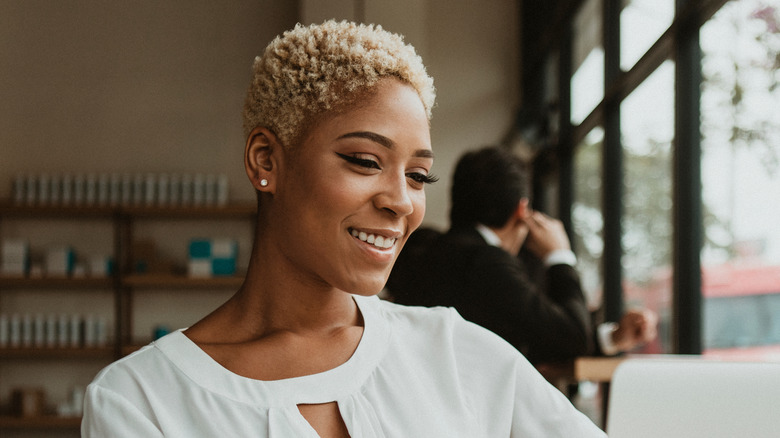 Cropped blond curly pixie cut