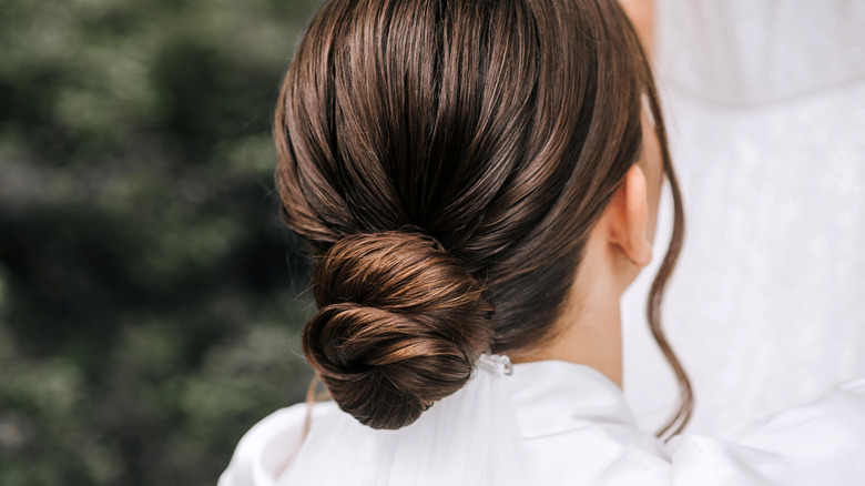 The back of a person's head showing a slick bun