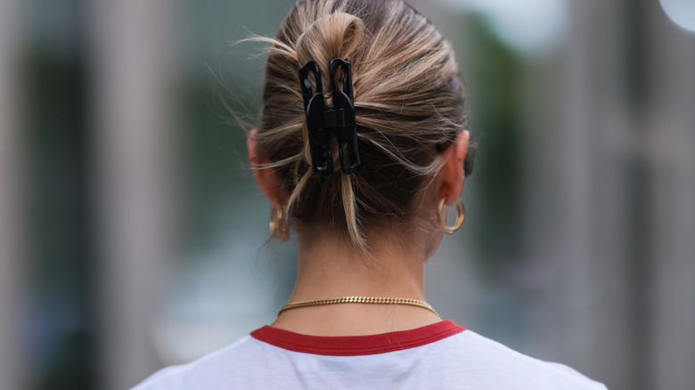 The back of a person wearing a chignon in a claw clip