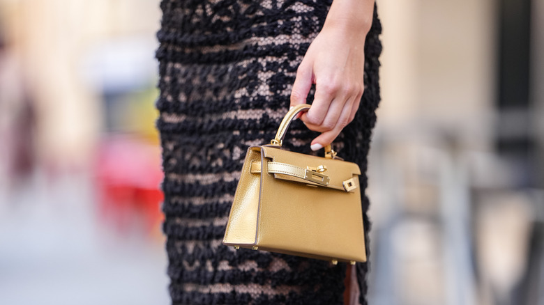 A woman carrying a yellow purse