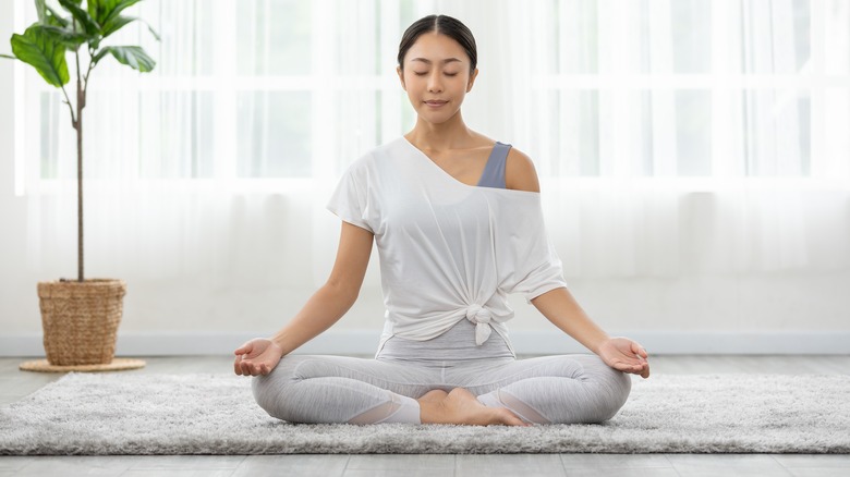 woman practicing yoga at home