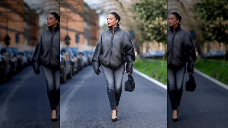 A person with faded skinny black jeans and a jacket