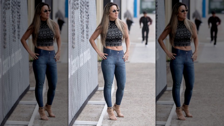 A person posing with dark jeggings and a tank top