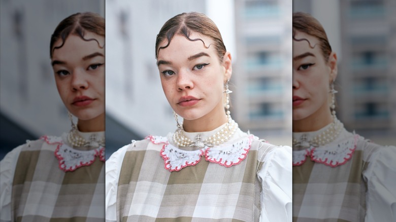 person in matching pearls