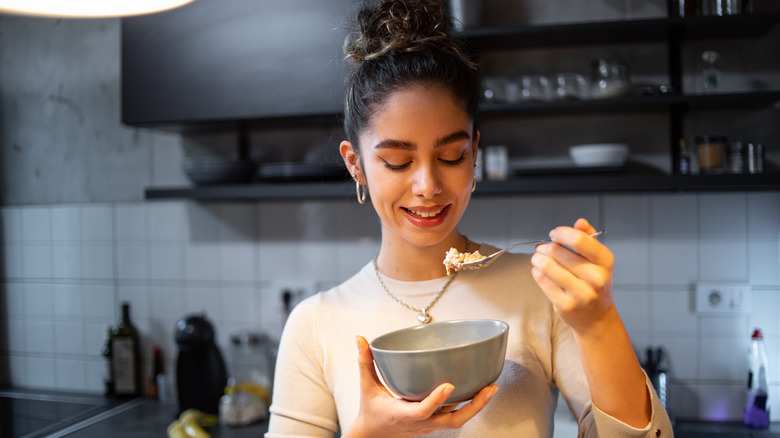 woman eating granola and yogurt