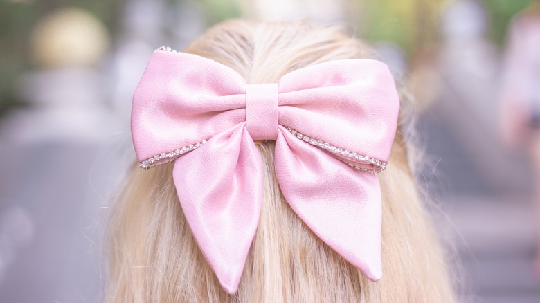 Blonde girl wearing pink bow