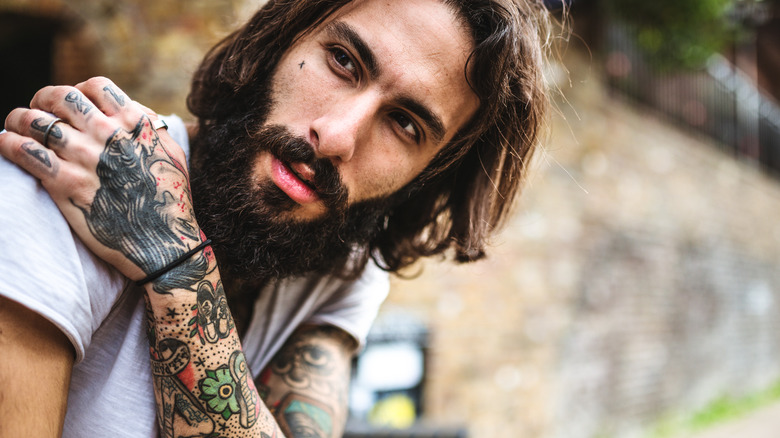 Handsome man with arm tattoos