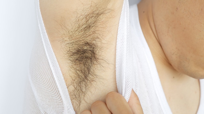 Person revealing their armpit hair