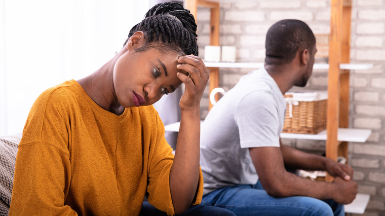 Upset couple sitting on couch