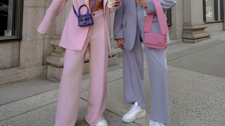 two woman wearing trousers