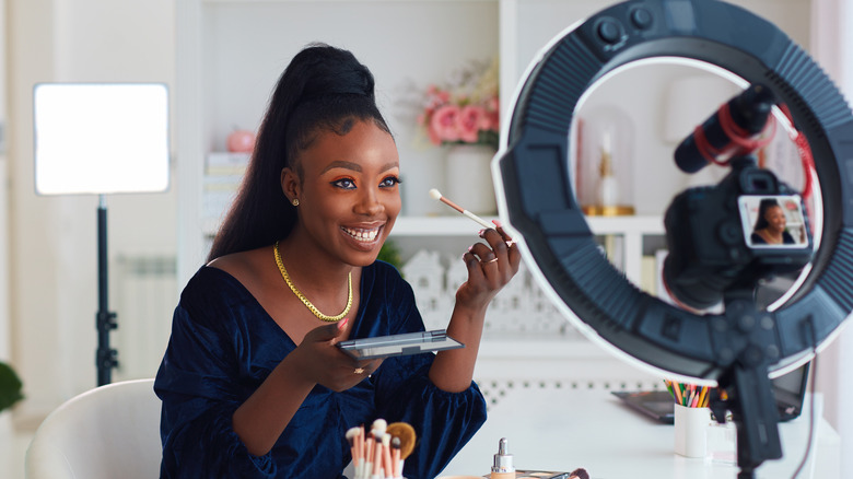 Content creator filming in bedroom