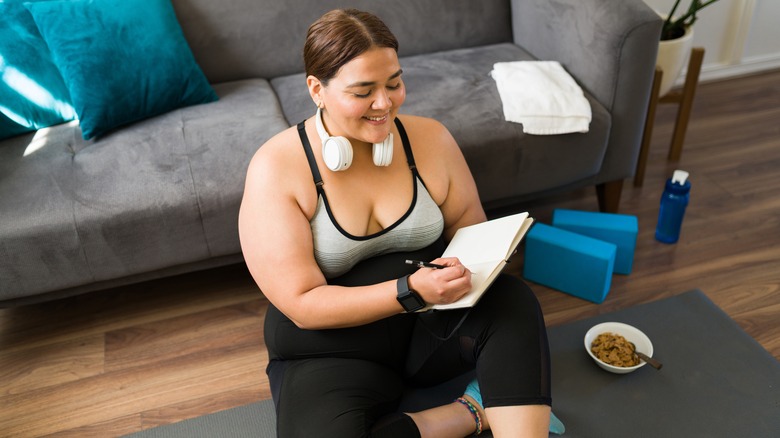 Woman journaling after yoga session