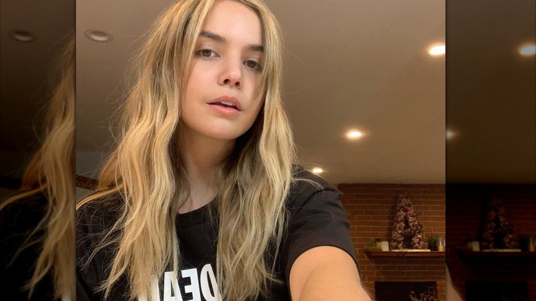 Madison Bailey wearing a black t-shirt