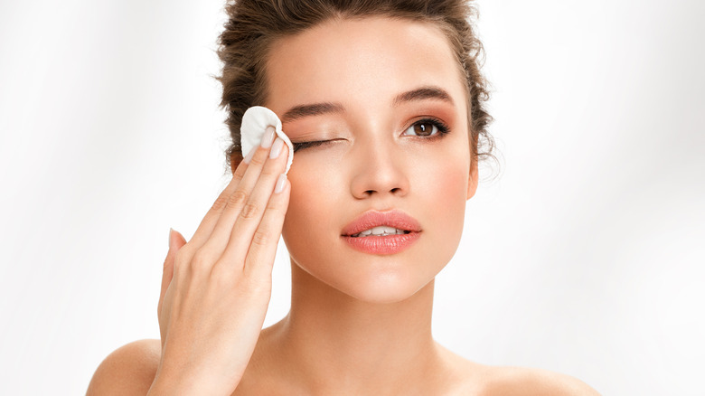 Woman removing makeup.