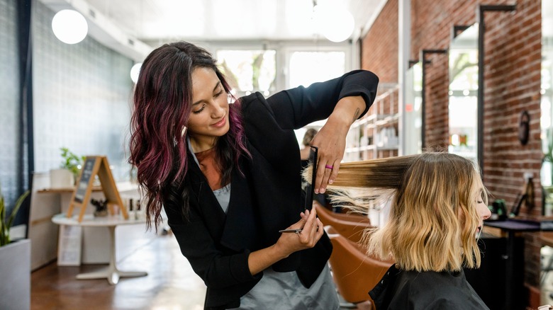Hairstylist cutting hair