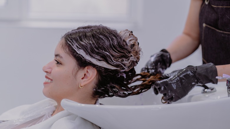 hairstylist toning client's hair