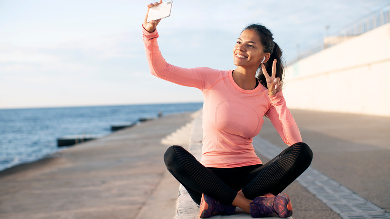 Woman sitting outside in long sleeve shirt