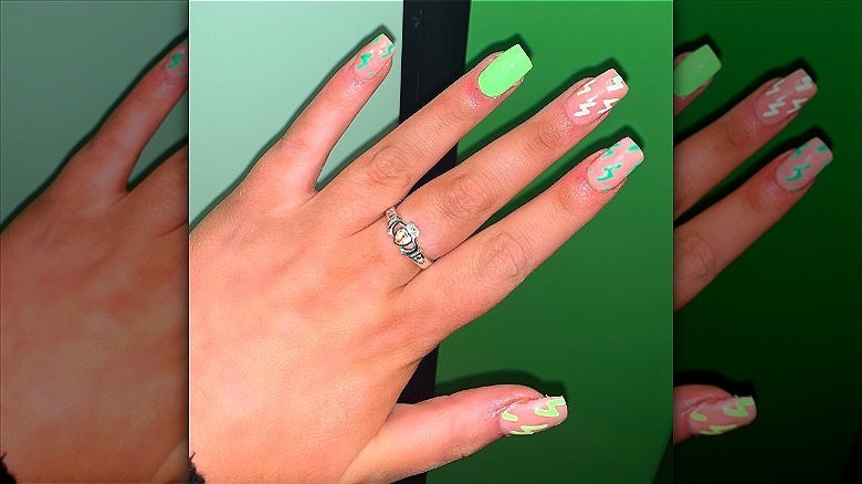 hands with mismatched lightning bolt manicure