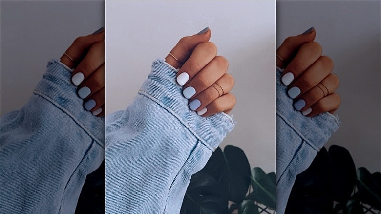 woman with blue pastel mismatched manicure