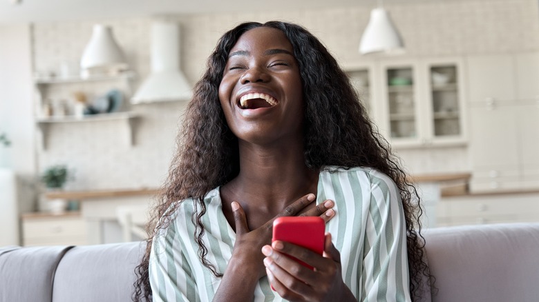 laughing woman texting