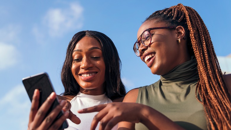 laughing woman texting with friends