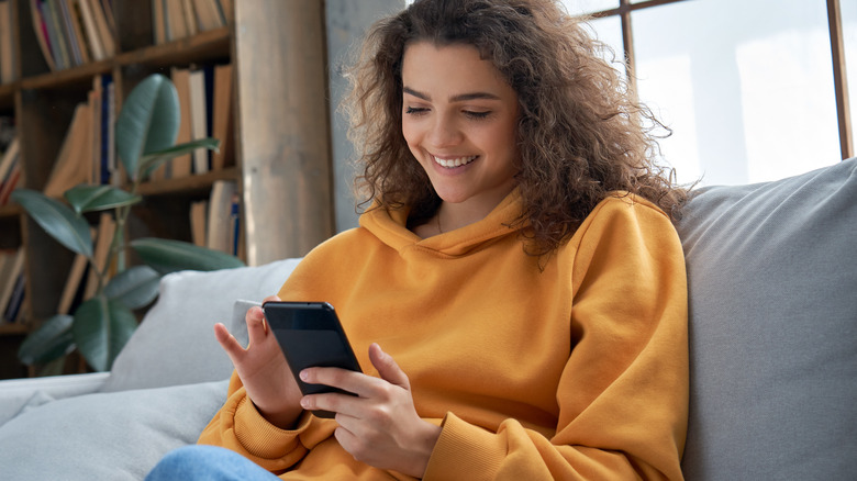 laughing woman texting