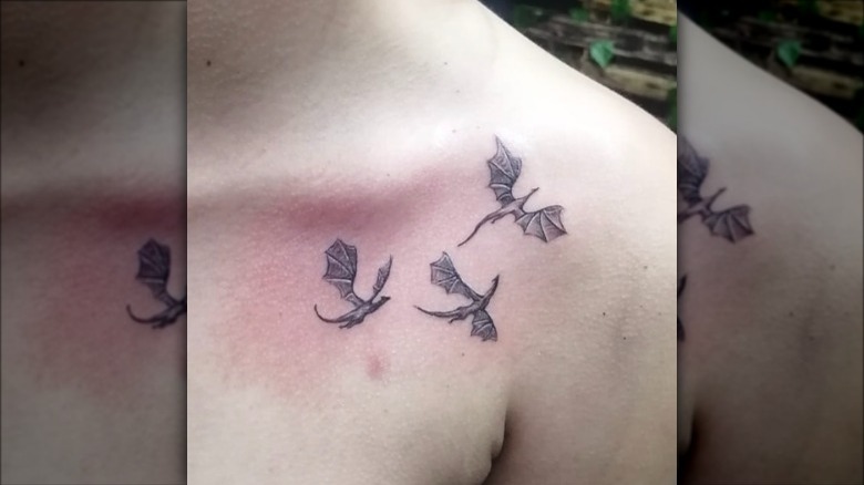 woman with dragons collarbone tattoo