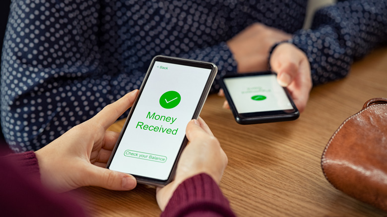 woman receiving money on phone