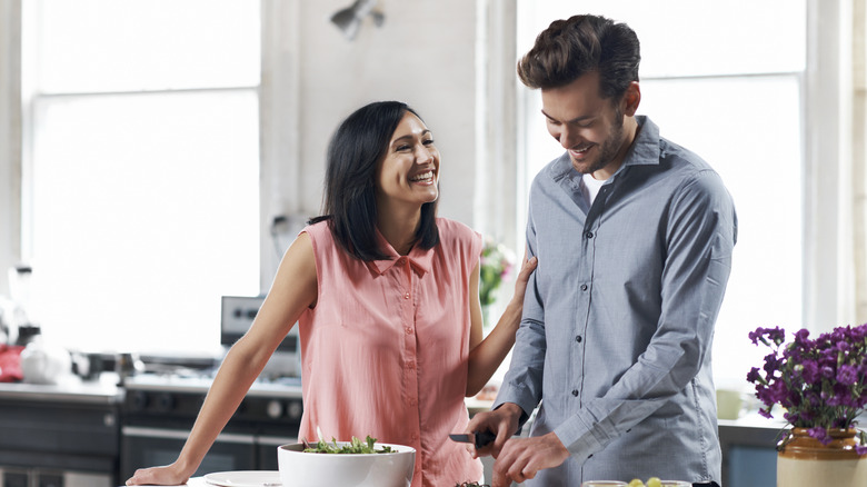 happy couple cooking