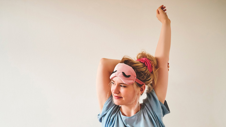 woman stretching in bed
