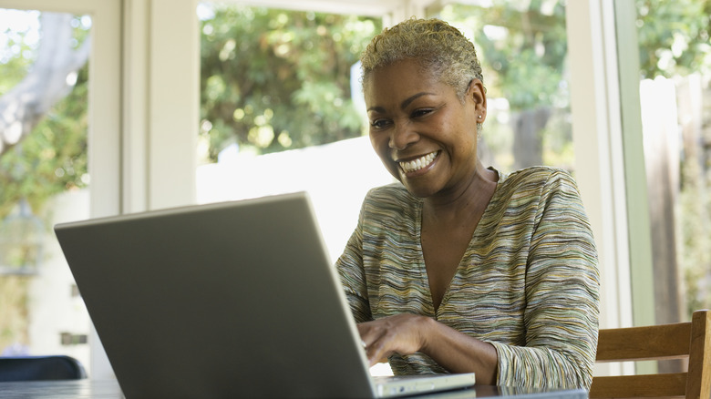 woman on laptop smiling