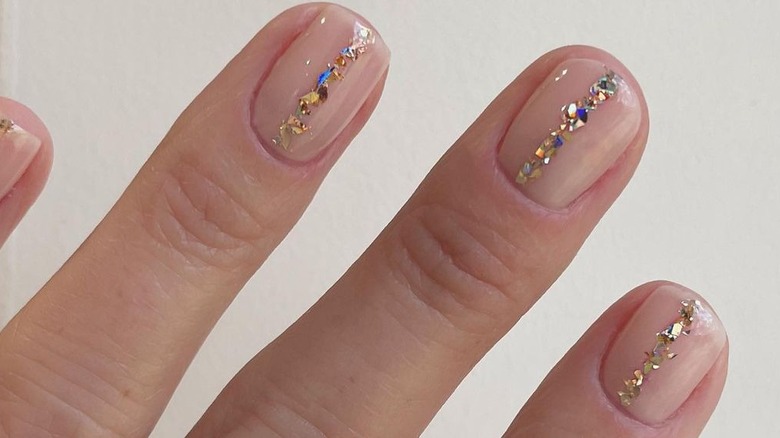 skin-tone nails with gold glitter polish